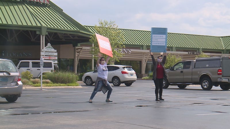 Volunteers cheer during TurningPoint Church's drive thru event at Lexington Green