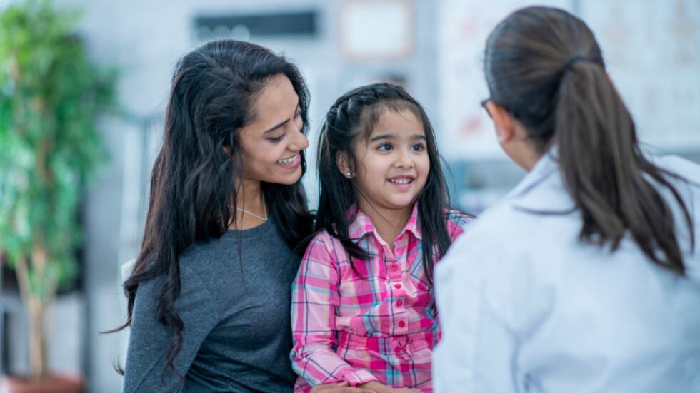 Mother and daughter with a medical profressional