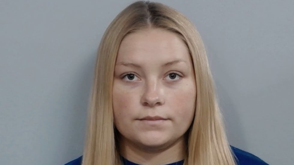 Laken Snelling, 21, was arrested Sunday and charged with abuse of a corpse, tampering with...