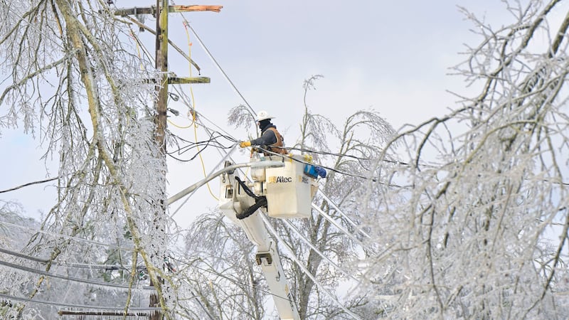A lineman works to restore power in Oxford, Miss. on Monday, Jan. 26, 2026, following a...