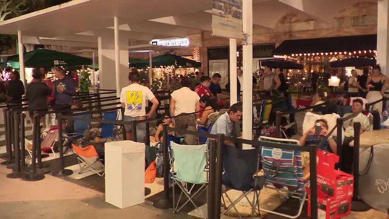 Customers waited outside the Apple store in Miami Beach as a line began forming Wednesday...